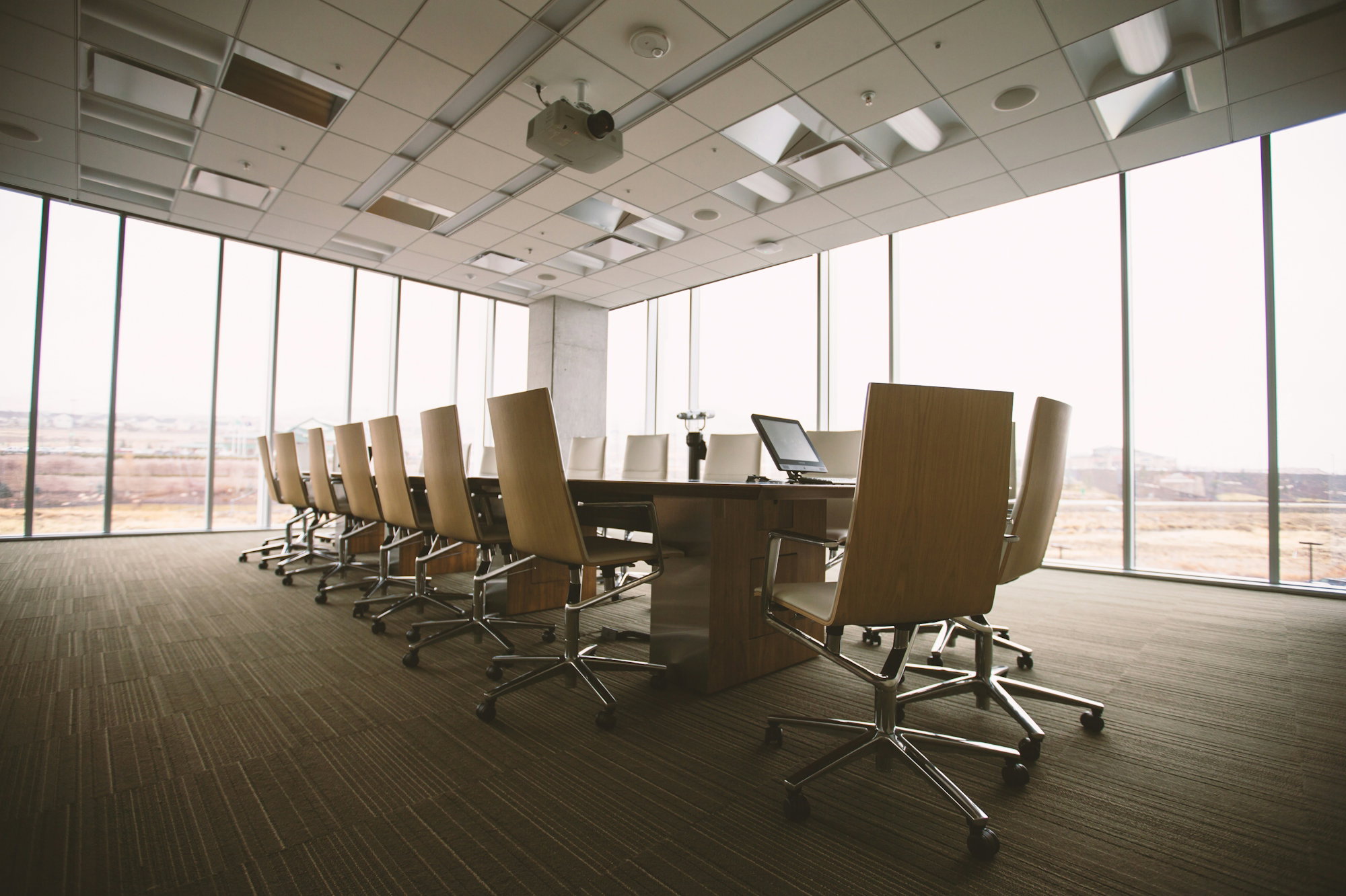 oval-brown-wooden-conference-table-and-chairs-inside-conference-room.jpg oval brown wooden conference table and chairs inside conference room